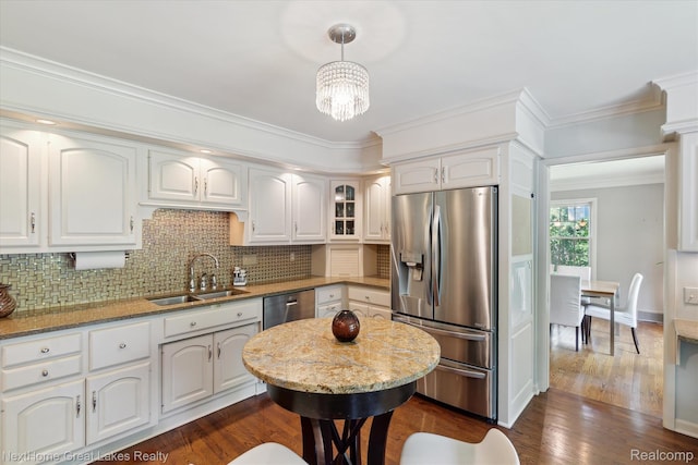 1831 Hampden Rd, Flint, MI 48503 - kitchen featuring appliances with stainless steel finishes, tasteful backsplash, white cabinetry, and crown molding