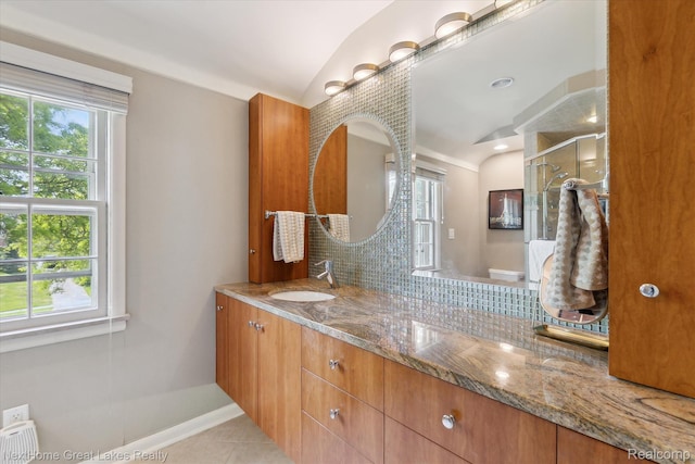1831 Hampden Rd, Flint, MI 48503 - bathroom featuring lofted ceiling, double vanity, tile patterned flooring, a shower with door, and tasteful backsplash