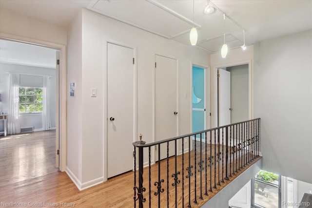 1831 Hampden Rd, Flint, MI 48503 - corridor featuring light wood-type flooring and an upstairs landing