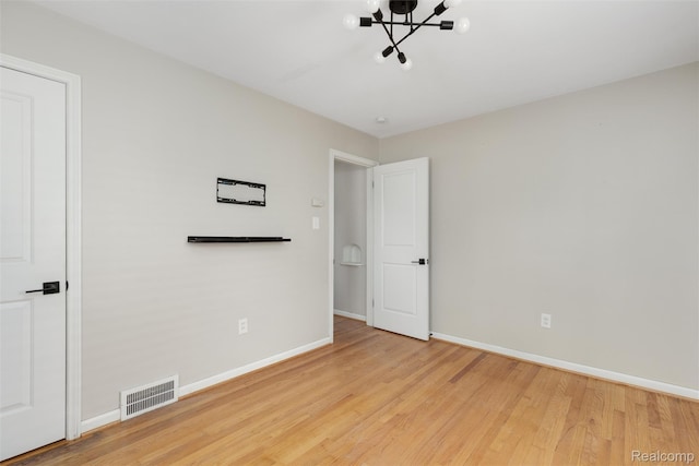 852 Cambridge Rd, Berkley, MI 48072 - unfurnished bedroom featuring a chandelier and wood finished floors