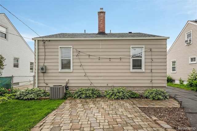 852 Cambridge Rd, Berkley, MI 48072 - back of property with a patio, a chimney, cooling unit, and a shingled roof