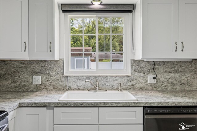 1115 Birchwood Dr, Temperance, MI 48182 - kitchen featuring black dishwasher, white cabinets, tasteful backsplash, and light countertops