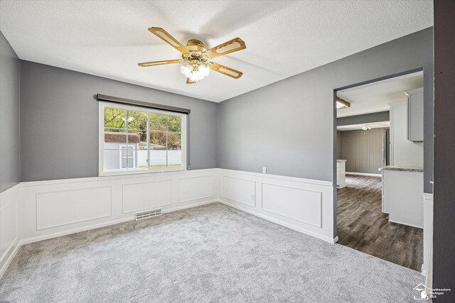1115 Birchwood Dr, Temperance, MI 48182 - carpeted spare room featuring ceiling fan, wainscoting, and a decorative wall