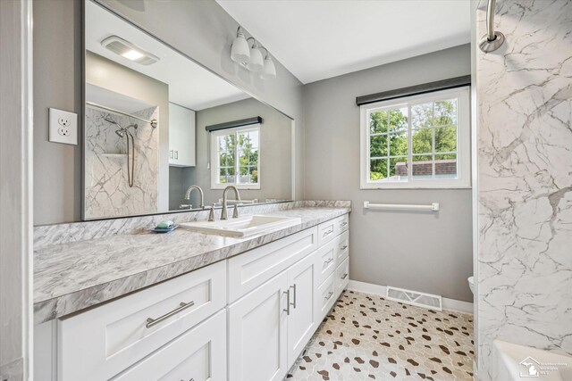 1115 Birchwood Dr, Temperance, MI 48182 - bathroom featuring vanity and a marble finish shower