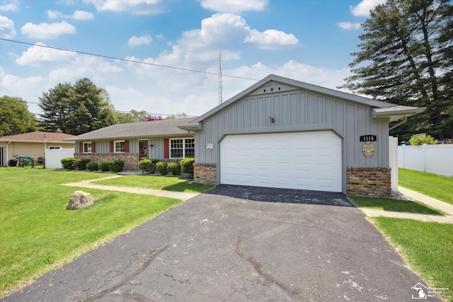 1115 Birchwood Dr, Temperance, MI 48182 - ranch-style house featuring board and batten siding, asphalt driveway, an attached garage, and brick siding
