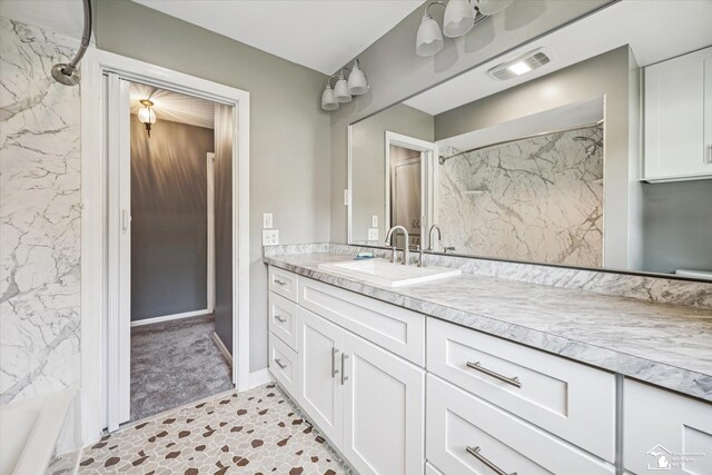 1115 Birchwood Dr, Temperance, MI 48182 - bathroom featuring vanity and a combined bath / shower with marble appearance