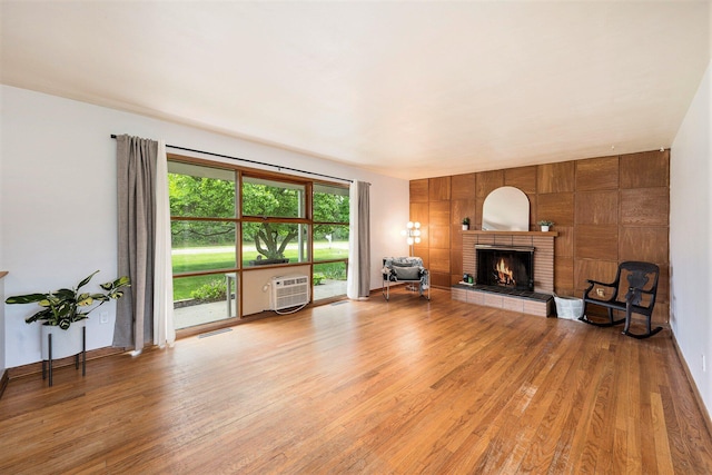 30151 Westfield St, Farmington Hills, MI 48334 - living area featuring light wood finished floors, a brick fireplace, and a wall mounted AC