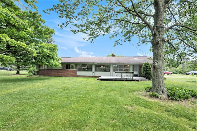 30151 Westfield St, Farmington Hills, MI 48334 - back of property with a yard, brick siding, a sunroom, and a wooden deck
