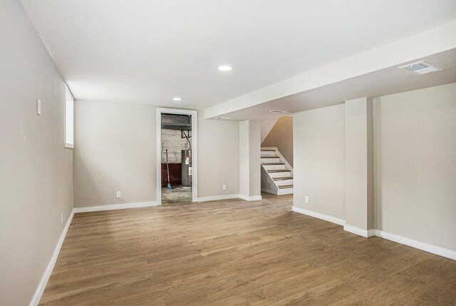 716 Langrick St, Sturgis, MI 49091 - finished basement featuring water heater, stairs, light wood finished floors, and recessed lighting