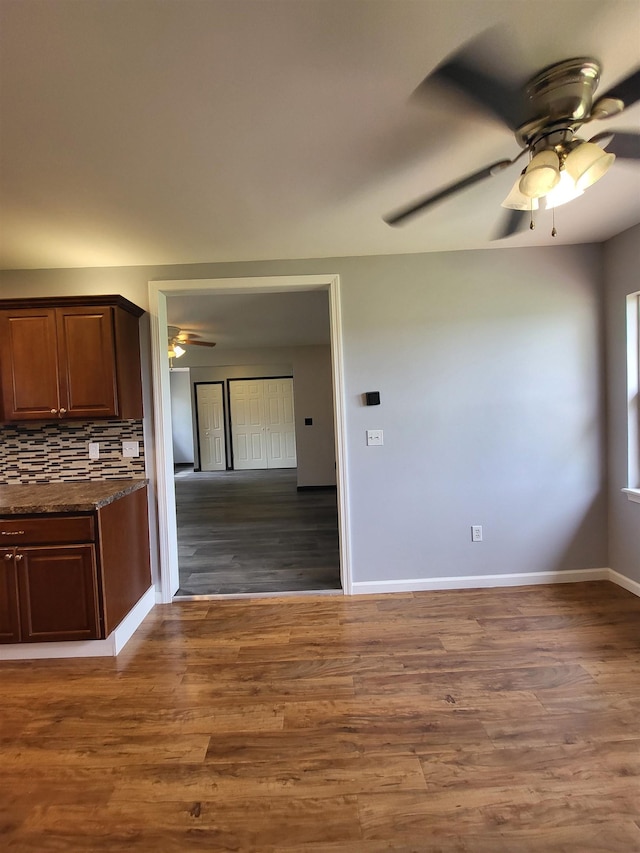 3456 N Irish Rd, Davison, MI 48423 - kitchen with ceiling fan, wood finished floors, backsplash, and dark stone counters