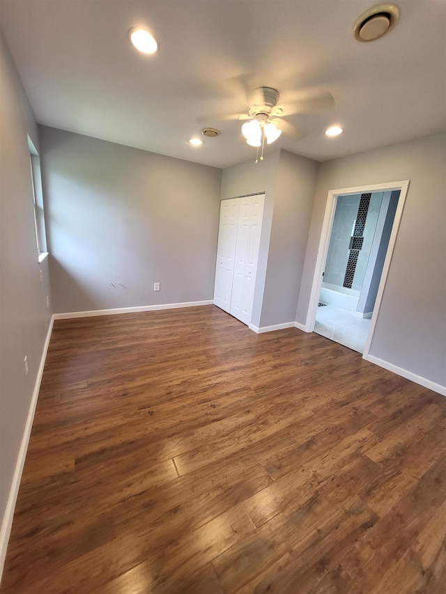 3456 N Irish Rd, Davison, MI 48423 - unfurnished bedroom with dark wood finished floors, recessed lighting, a closet, and ceiling fan