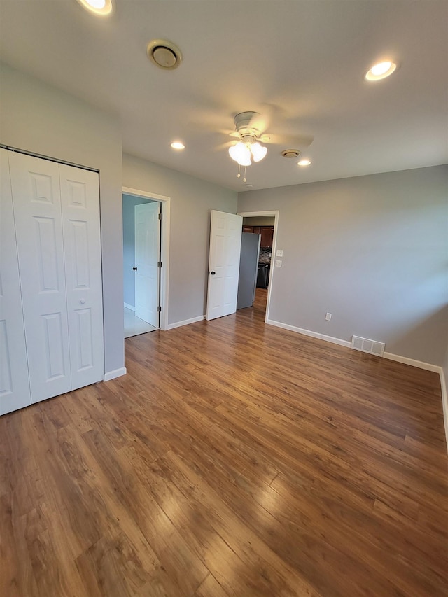 3456 N Irish Rd, Davison, MI 48423 - unfurnished bedroom featuring wood finished floors, recessed lighting, ceiling fan, and a closet