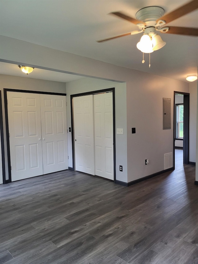 3456 N Irish Rd, Davison, MI 48423 - unfurnished bedroom featuring electric panel, dark wood-style flooring, and a ceiling fan