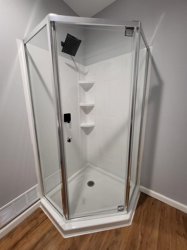 3456 N Irish Rd, Davison, MI 48423 - full bathroom with a shower stall and wood finished floors