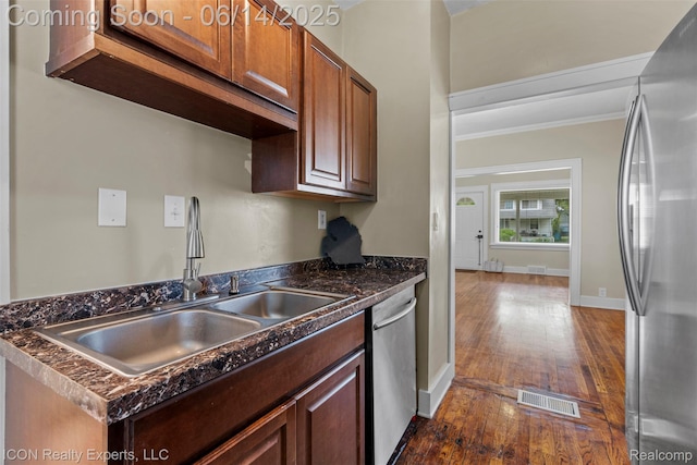 246 E Chesterfield St, Ferndale, MI 48220 - kitchen featuring appliances with stainless steel finishes, dark countertops, crown molding, and dark wood-style floors