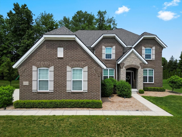 13531 Brampton Ct, Utica, MI 48315 - view of front of house featuring brick siding, a front yard, and roof with shingles