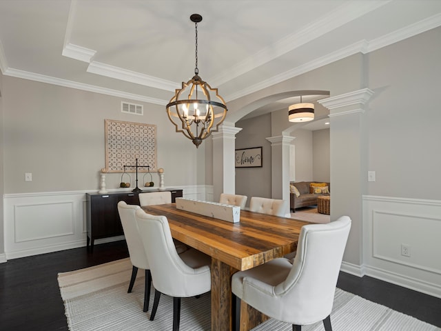 13531 Brampton Ct, Utica, MI 48315 - dining room with ornate columns, arched walkways, a decorative wall, dark wood-type flooring, and crown molding