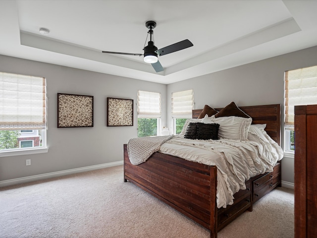 13531 Brampton Ct, Utica, MI 48315 - bedroom with a tray ceiling, light colored carpet, and a ceiling fan