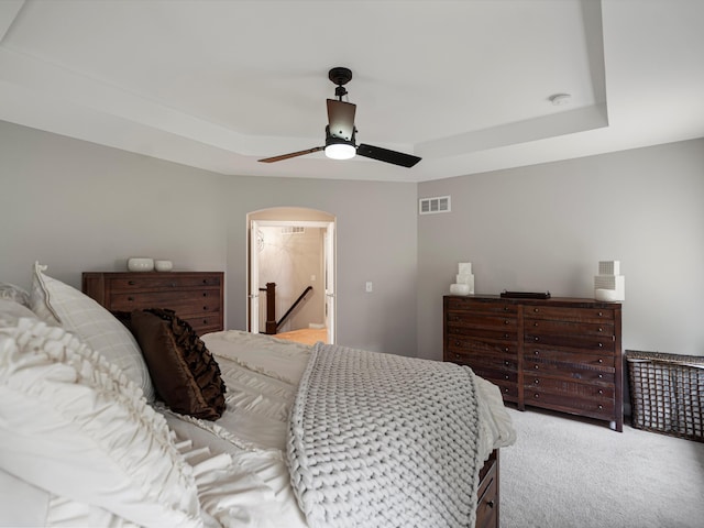13531 Brampton Ct, Utica, MI 48315 - bedroom with a tray ceiling, carpet floors, and a ceiling fan