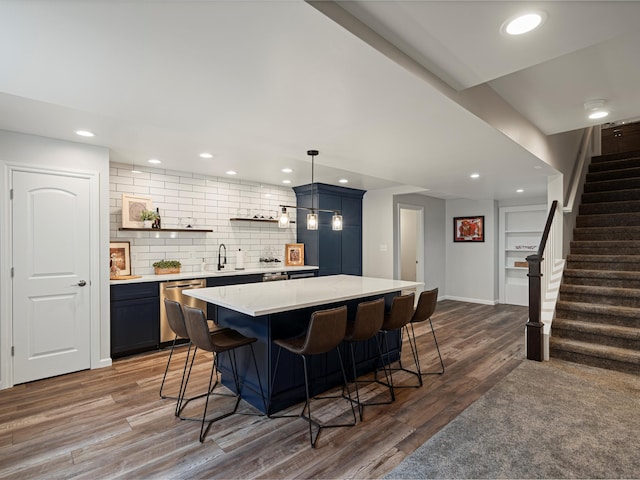 13531 Brampton Ct, Utica, MI 48315 - kitchen featuring dishwasher, light countertops, a kitchen breakfast bar, wood finished floors, and tasteful backsplash