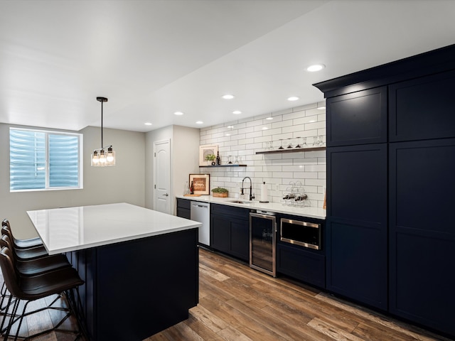 13531 Brampton Ct, Utica, MI 48315 - kitchen featuring beverage cooler, stainless steel appliances, tasteful backsplash, a kitchen bar, and light countertops