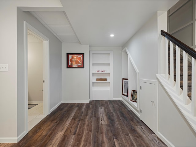 13531 Brampton Ct, Utica, MI 48315 - hallway featuring built in shelves, dark wood-style floors, stairs, and recessed lighting