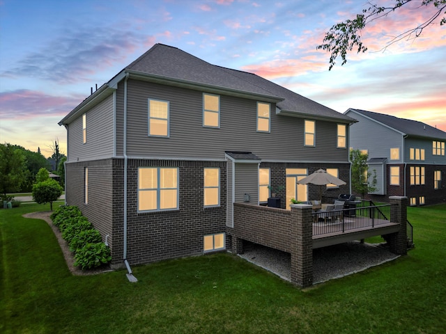13531 Brampton Ct, Utica, MI 48315 - rear view of house featuring a yard, a deck, and brick siding