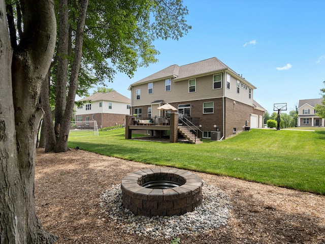 13531 Brampton Ct, Utica, MI 48315 - back of house featuring stairway, an outdoor fire pit, a deck, brick siding, and a garage