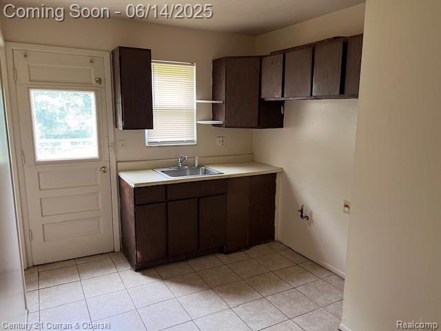 6423-25 Evergreen Rd, Detroit, MI 48228 - kitchen featuring light tile patterned floors, dark brown cabinets, light countertops, and open shelves