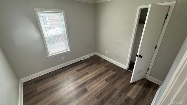 18615 Brohl St, Roseville, MI 48066 - unfurnished bedroom with multiple windows, dark wood finished floors, and crown molding