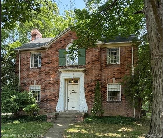 1212 Whittier Rd, Ypsilanti, MI 48197 - view of front of house with a chimney and brick siding