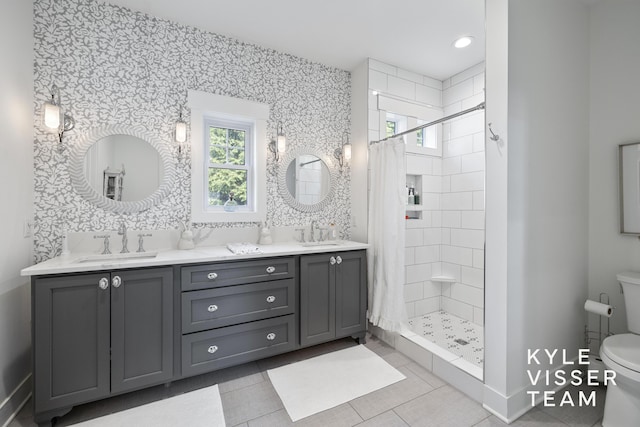 3 Woodward Ln SE, Grand Rapids, MI 49506 - bathroom featuring double vanity, a stall shower, and tile patterned flooring