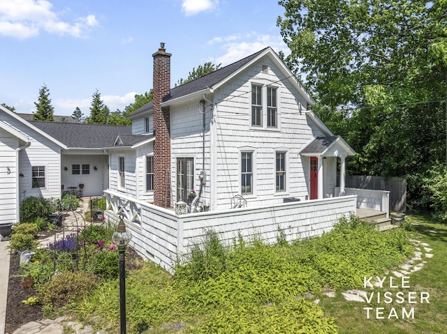3 Woodward Ln SE, Grand Rapids, MI 49506 - view of side of home featuring a chimney and a shingled roof