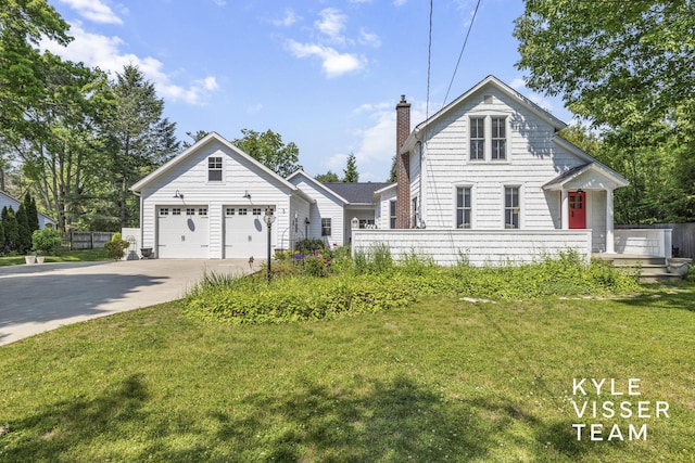 3 Woodward Ln SE, Grand Rapids, MI 49506 - traditional home featuring concrete driveway, a chimney, and a garage