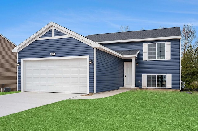 13741 Oasis Ave, Holland, MI 49424 - view of front of home with a front yard, an attached garage, driveway, and a shingled roof