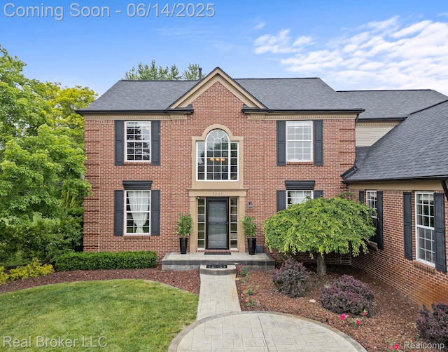 7235 Goldenrod Ct, Brighton, MI 48116 - colonial home featuring a front lawn, brick siding, and a shingled roof