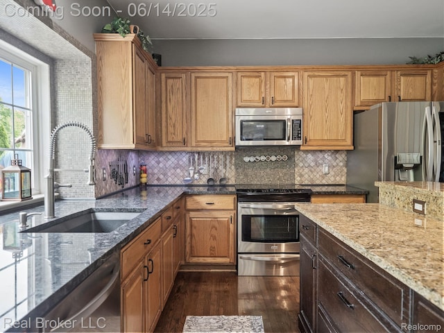 7235 Goldenrod Ct, Brighton, MI 48116 - kitchen featuring stainless steel appliances, dark wood-style flooring, light stone countertops, and tasteful backsplash