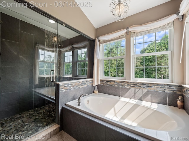 7235 Goldenrod Ct, Brighton, MI 48116 - bathroom with a shower stall, a chandelier, a garden tub, tile patterned flooring, and lofted ceiling