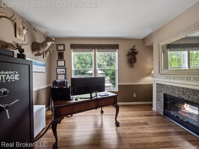 7235 Goldenrod Ct, Brighton, MI 48116 - office with healthy amount of natural light, wood finished floors, and a glass covered fireplace