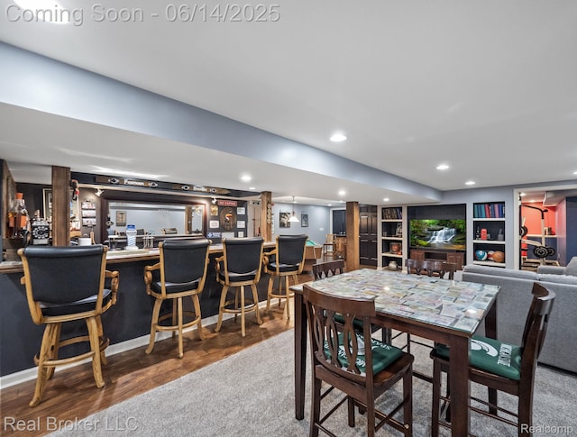 7235 Goldenrod Ct, Brighton, MI 48116 - dining room featuring bar, wood finished floors, recessed lighting, and built in features