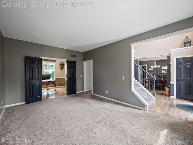7235 Goldenrod Ct, Brighton, MI 48116 - spare room featuring a chandelier, carpet, and stairs