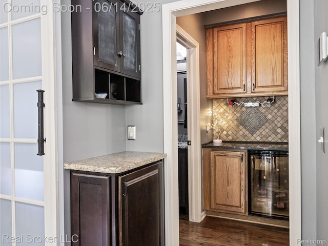 7235 Goldenrod Ct, Brighton, MI 48116 - indoor dry bar featuring wine cooler, backsplash, and dark wood-style flooring