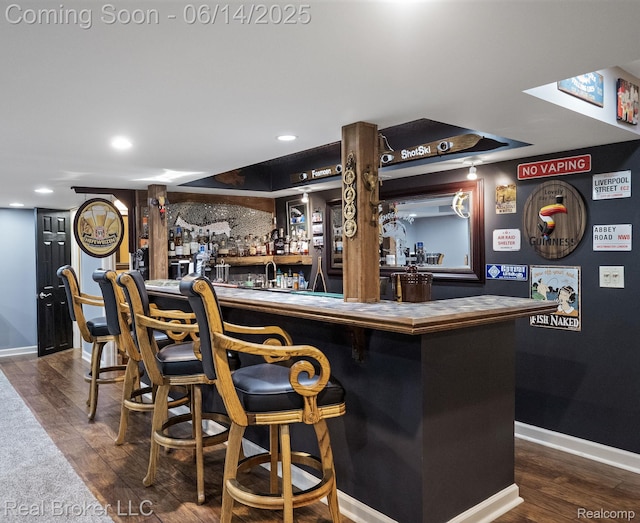 7235 Goldenrod Ct, Brighton, MI 48116 - indoor wet bar featuring dark wood-style floors and recessed lighting
