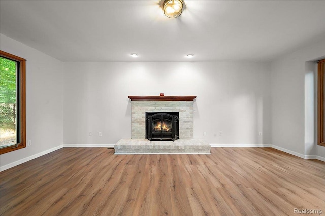 2696 Cedar Key Dr, Lake Orion, MI 48360 - unfurnished living room featuring wood finished floors and a brick fireplace
