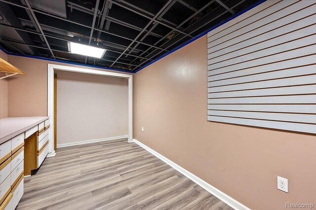 2696 Cedar Key Dr, Lake Orion, MI 48360 - finished basement with light wood-style flooring and baseboards