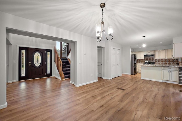 2696 Cedar Key Dr, Lake Orion, MI 48360 - entrance foyer with stairs, a chandelier, light wood-type flooring, and recessed lighting