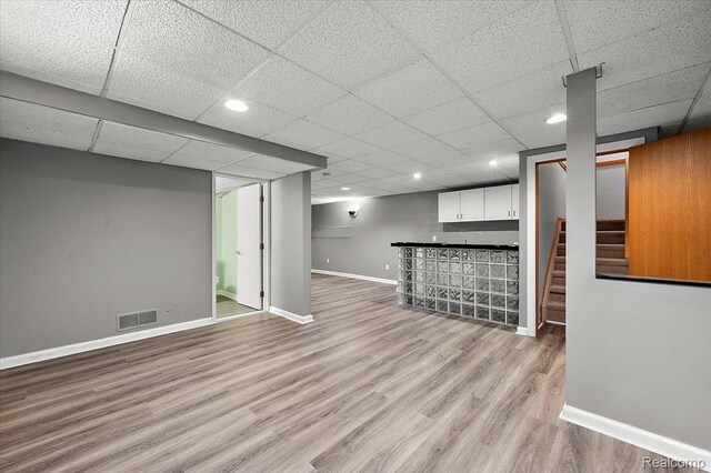 2696 Cedar Key Dr, Lake Orion, MI 48360 - finished basement with a dry bar, wood finished floors, stairway, and a drop ceiling