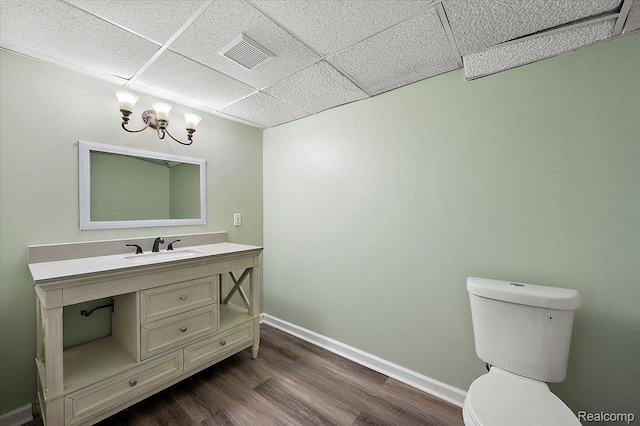 2696 Cedar Key Dr, Lake Orion, MI 48360 - half bath with a drop ceiling, vanity, wood finished floors, and a chandelier