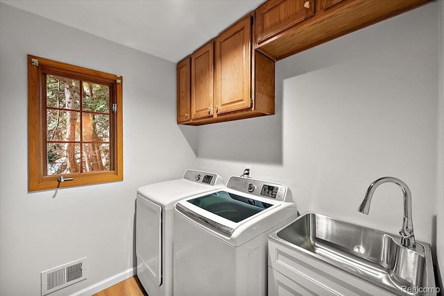 2696 Cedar Key Dr, Lake Orion, MI 48360 - washroom with separate washer and dryer and cabinet space