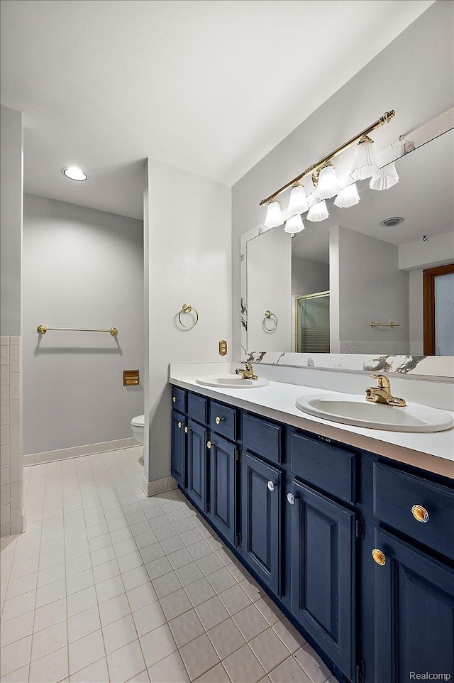 2696 Cedar Key Dr, Lake Orion, MI 48360 - bathroom with double vanity, a shower with shower door, tile patterned floors, and recessed lighting